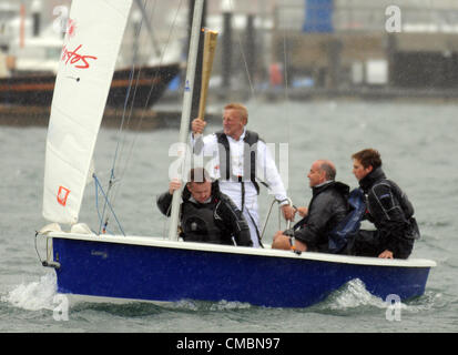 La flamme olympique a fait son chemin par la mer, mais seulement après un changement de dernière minute du plan. Avec des vents et de la pluie c'était dangereux d'autoriser deux jeunes à faire la traversée à Weymouth sorte Rodney Pattisson Stuart MBE, un ancien gagnant de la médaille d'or en double a pris la flamme dans un yacht de la Sailing Academy à Portland. Il a remporté le double de médailles d'or aux Jeux olympiques de voile à l'Jeux olympiques de Mexico 1968 et 1972 Jeux Olympiques de Munich. 12/07/2012 Photo par : DORSET MEDIA SERVICE Banque D'Images