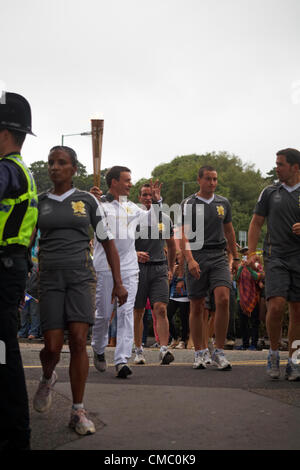 Bournemouth, UK Vendredi 13 juillet 2012. Relais du flambeau olympique à Bournemouth, Royaume-Uni - runner Ian Kennedy, entraîneur du Club d'athlétisme Wimborne, prend le flambeau dans les jardins bas à Bournemouth le vendredi soir Banque D'Images