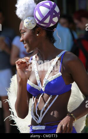 Londres, Royaume-Uni. La torche olympique est transmises par l'entremise de Notting Hill Gate à Kensington et Chelsea dans l'après-midi du 26 juillet 2012 Prix de la Couronne par Frederik de Danemark. La foule et les danseurs de profiter de la journée. Banque D'Images