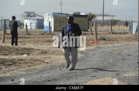 17Th Aug 2012. RUSTENBURG, AFRIQUE DU SUD : Prêtre Daniel Bavuma marcher sur la scène de la fusillade qui a eu lieu en dehors de l'établissement informel Nkaneng près de la mine de Lonmin le 17 août 2012 dans le nord-ouest, Afrique du Sud. Il a été confirmé que 34 mineurs en grève ont été tués, et 78 blessés. (Photo par Gallo Images / Photos / Felix24 Dlangamandla). Credit : Gallo images / Alamy Live News Banque D'Images