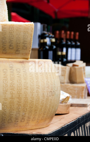 Le Parmigiano Reggiano et autres produits italiens en vente sur un étal au marché de l'arrondissement. Banque D'Images