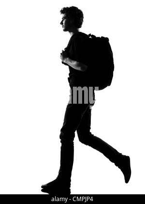 Jeune homme backpacker randonnée silhouette en studio isolé sur fond blanc Banque D'Images