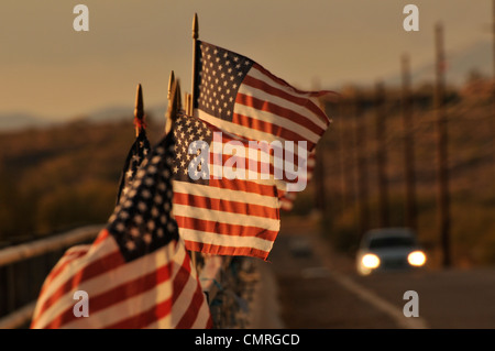 Drapeaux américain attaché à un pont au-dessus de la rivière de Santa Cruz dans le vent souffler à Green Valley, Arizona, USA. Banque D'Images