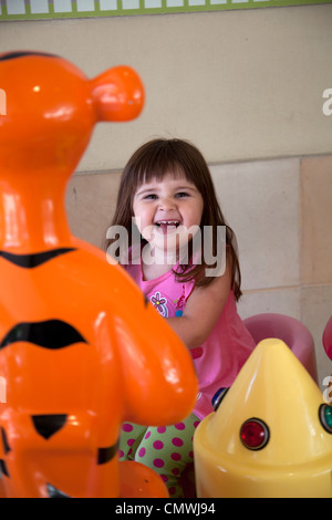 Fille sur le carrousel de bébé Banque D'Images