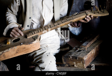 Les Népalais l'homme joue sur sa guitare fait main ,photo a été prise dans son atelier Banque D'Images