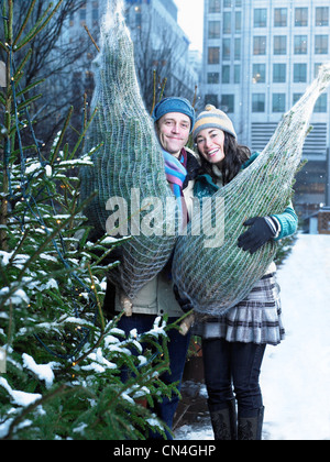 Couple qui achète des arbres de Noël
