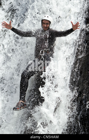 Homme adulte en ordre décroissant dans une cascade de tirer le niveau d'eau Banque D'Images