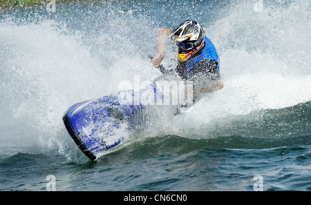 Jet ski sur le lac avec un jet d'eau derrière Banque D'Images