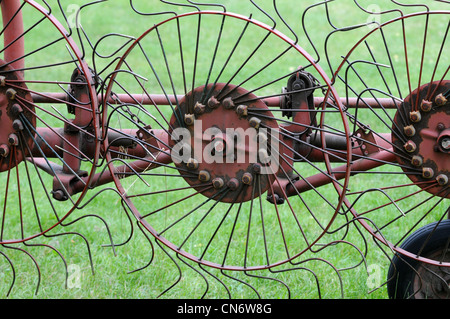 Hay turner rusty ancienne machine sur campagne dans la région de Mazovie (Mazowsze) en Pologne Banque D'Images