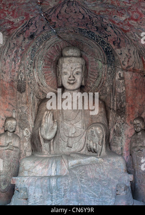 Sculptures en pierre de Bouddha et ses disciples au milieu grotte Binyang dans les grottes de Longmen site en Chine Banque D'Images