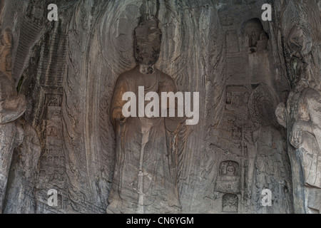 Sculptures en pierre de Bouddha et ses disciples au milieu grotte Binyang dans les grottes de Longmen site en Chine Banque D'Images
