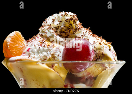 La crème glacée et les fruits dans un bol en verre Banque D'Images