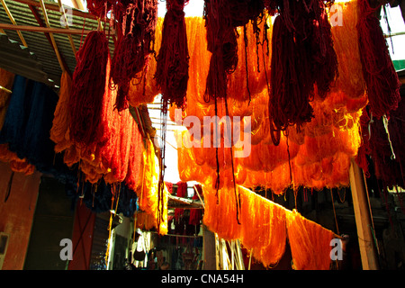 Les poulies de fraîchement teints en rouge et jaune dans le séchage laine accrocher souk des Teinturiers/Souq des Sebbaghine dans la médina, Marrakech, Maroc Banque D'Images