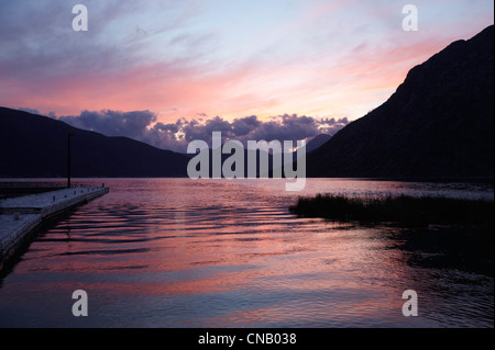 Ciel coucher de soleil reflété dans le lac encore Banque D'Images