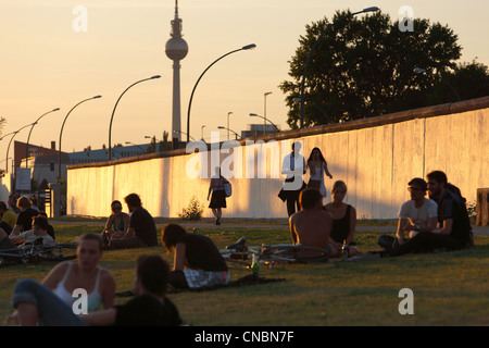 Les jeunes au coucher du soleil sur la East-Side-Gallery, Berlin, Allemagne Banque D'Images