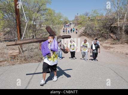 Pilgrim portant une croix sur son chemin à la Sanctuaire Chimayo, Nouveau Mexique, au cours de la semaine de Pâques. Banque D'Images