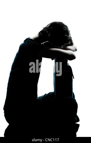 Portrait d'un jeune ado fille silhouette triste à pleurer en pleine longueur studio cut out isolé sur fond blanc Banque D'Images