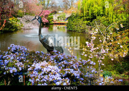 Fleurs de Printemps et de la sculpture heron, Shrewsbury Shropshire Angleterre Dingle Banque D'Images