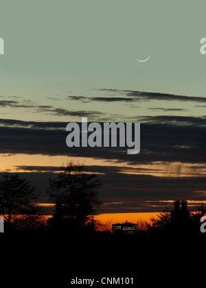 2 jours croissant de lune avec lumière cendrée au-dessus d'un immeuble de bureaux à Londres au coucher du soleil Banque D'Images