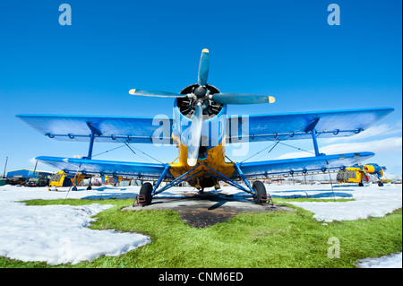 Des avions en stationnement sur une prairie avec de la neige dans une journée ensoleillée Banque D'Images