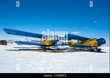 Des avions en stationnement sur une prairie avec de la neige dans une journée ensoleillée Banque D'Images