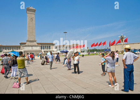 Les touristes chinois de la Place Tiananmen, la prise de photographies de l'autre avec le monument aux héros du peuple et le grand Hal Banque D'Images