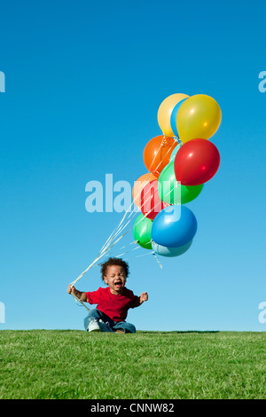 Crying Boy with Balloons Banque D'Images