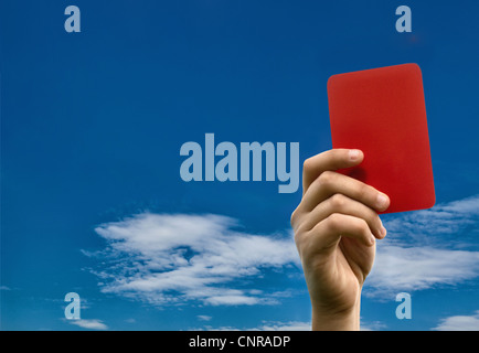 Hand holding carton rouge contre le ciel bleu Banque D'Images