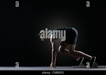 Runner sur bloc de départ Banque D'Images