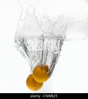 Citrons splashing in water Banque D'Images