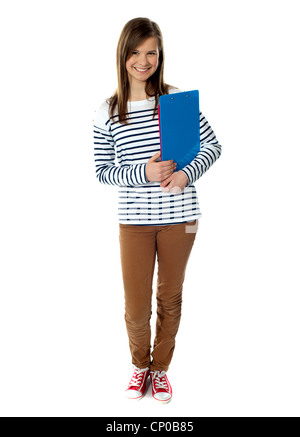 Young Girl smiling in front of camera, holding folders Banque D'Images