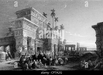 Foule d'Arabes dans le désert avec des bâtiments en arrière-plan de l'Égypte ancienne sous ciel étoilé. Banque D'Images