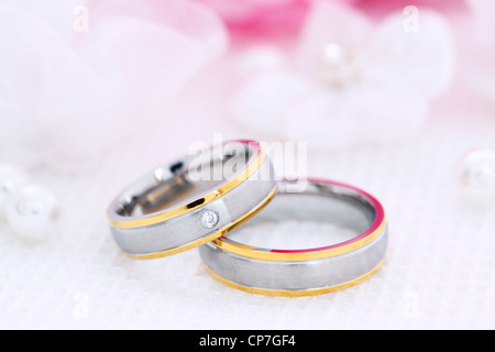 La vie encore de mariage avec de belles bagues en or et bouquet en arrière-plan Banque D'Images