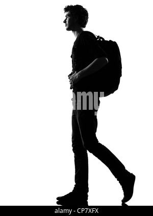 Jeune homme backpacker randonnée silhouette en studio isolé sur fond blanc Banque D'Images
