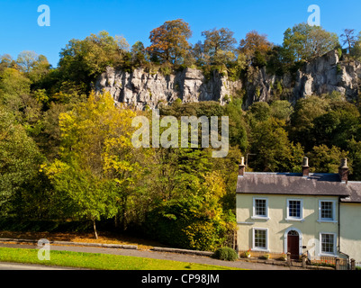 Falaises calcaires populaire avec des grimpeurs à Matlock Bath village Derbyshire Peak District England UK avec cottage en face Banque D'Images