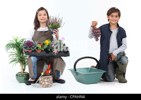 Petite fille vêtue d'un fleuriste et un petit garçon habillé en vendangeuse Banque D'Images