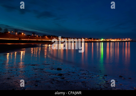 Rhos on sea dans la nuit avec l'éclairage de rue reflétée dans les eaux de la soirée. Banque D'Images