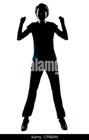 Portrait d'un jeune adolescent silhouette garçon ou fille heureux sautant hurlant toute la longueur en studio cut out isolé sur fond blanc Banque D'Images