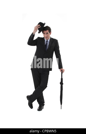 Businessman avec un chapeau et ombrelle Banque D'Images