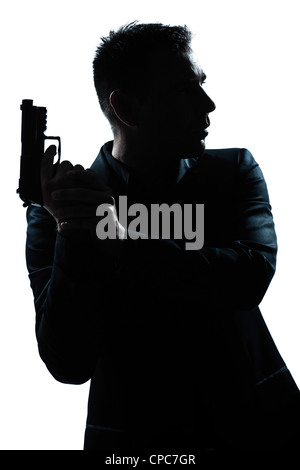 Portrait d'un criminel d'espionnage policier detective man holding gun portrait silhouette en studio isolé sur fond blanc Banque D'Images