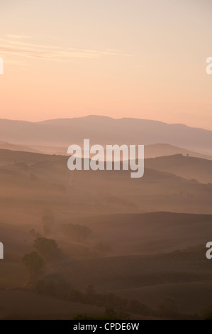 L'aube d'une vue sur les collines de Misty Val d'Orcia, UNESCO World Heritage Site, Toscane, Italie, Europe Banque D'Images