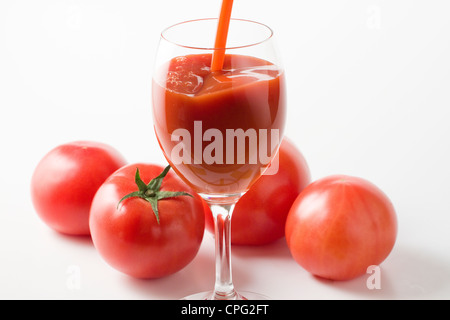 Verre de jus de tomate avec des tomates Banque D'Images