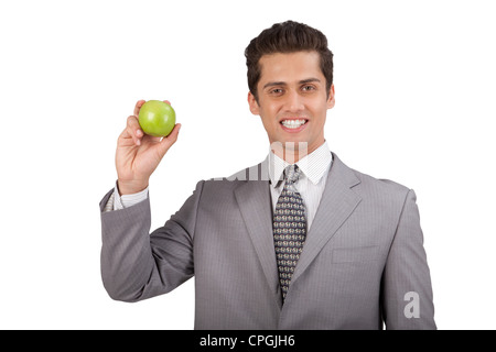 Businessman holding an apple. Banque D'Images