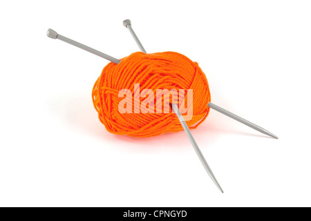 Ball of orange wool with knitting needles over white Banque D'Images