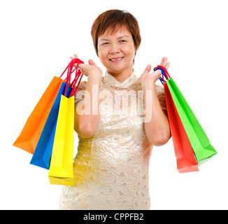 Mature Asian shopper holding Shopping bag isolated on white background Banque D'Images