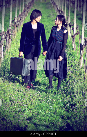 Vagabond est un couple marche main dans la main à travers un champ de vignes Banque D'Images