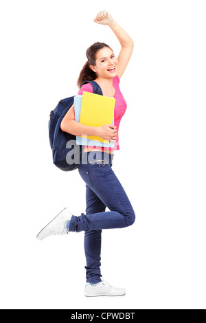 Portrait of a happy schoolgirl holding notebooks contre isolé sur fond blanc Banque D'Images