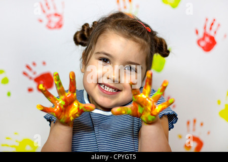 Heureux l'enfant joue dans la peinture à la maison lors de la rénovation Banque D'Images