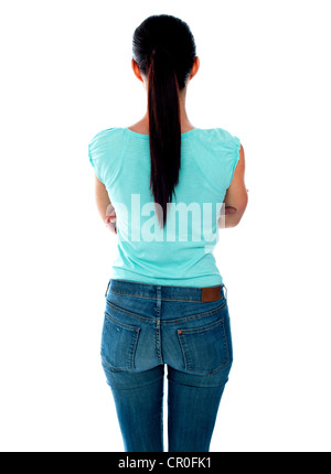 Belle jeune femme à la recherche au mur. Vue arrière. Isolated over white. Banque D'Images