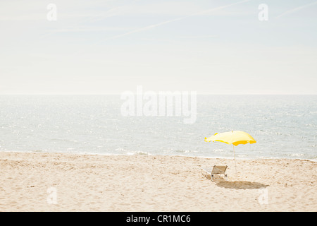 Chaise longue et parasol sur la plage Banque D'Images